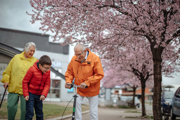 istock Old people walking in the spring with grandson 1389269196