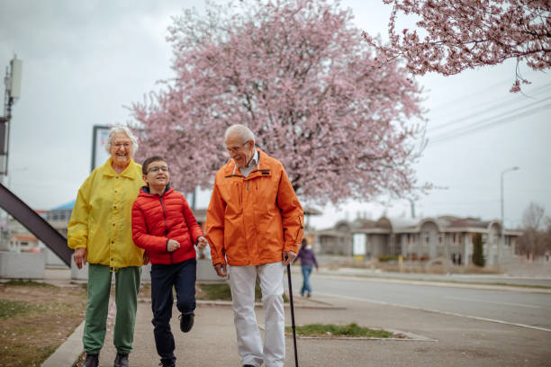istock Old people walking in the spring with grandson 1389270233