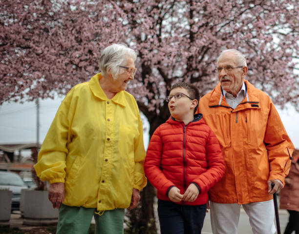 istock Old people walking in the spring with grandson 1389270297
