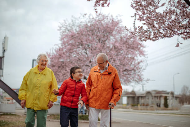 istock Old people walking in the spring with grandson 1389270316