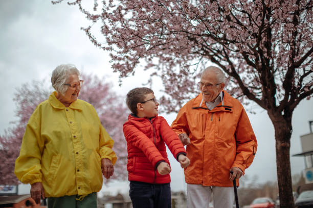 istock Old people walking in the spring with grandson 1389270375