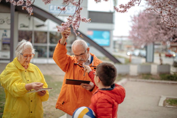 istock Old people walking in the spring holding digital tablets 1389270394