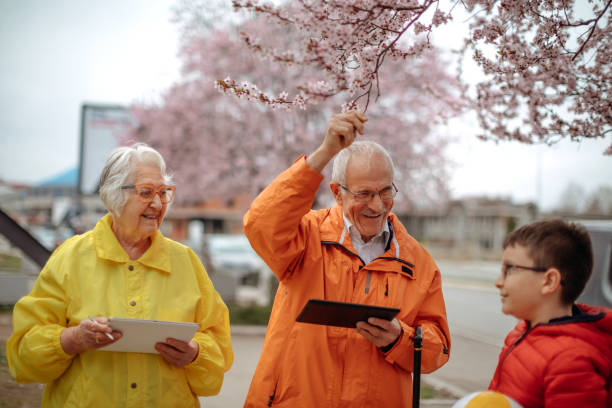 istock Old people walking in the spring holding digital tablets 1389270412