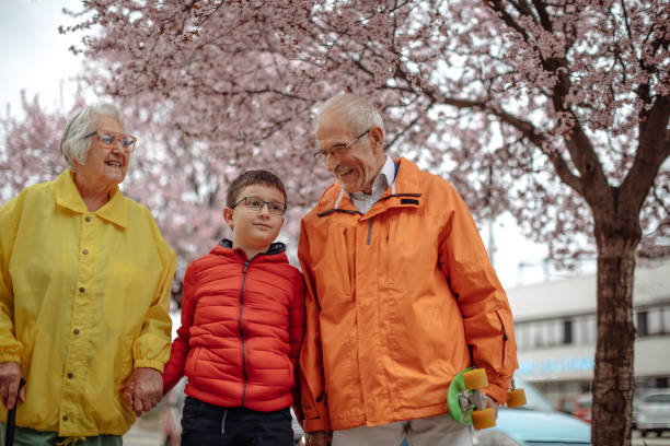istock Old people walking in the spring with grandson 1389270432