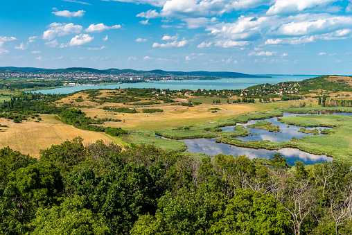 Overview from a viewpoint over Lake Balaton with a forest and Morr area in the foreground