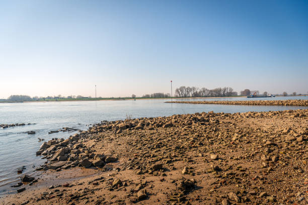 istock Wet riverbank covered with stones 1389272629