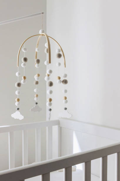 istock cute cloud mobile hanging on crib in nursery room 1389273378