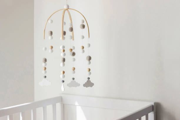 istock cute cloud mobile hanging on crib in nursery room 1389273384