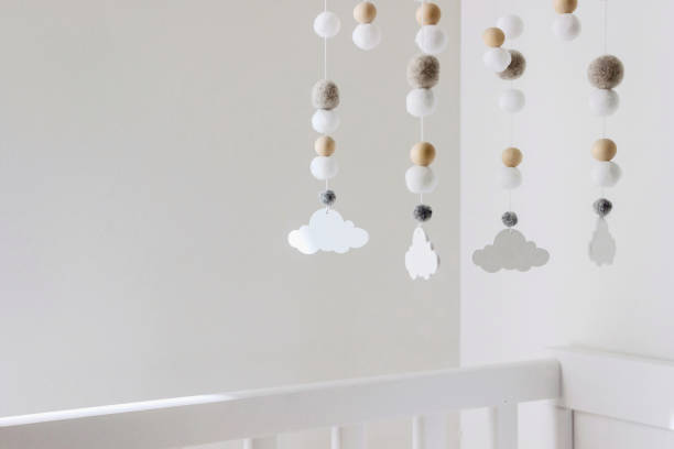 istock cute cloud mobile hanging on crib in nursery room 1389273394