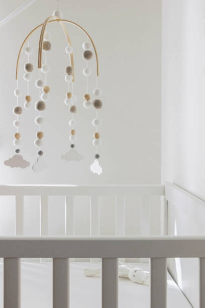 istock cute cloud mobile hanging on crib in nursery room 1389273425