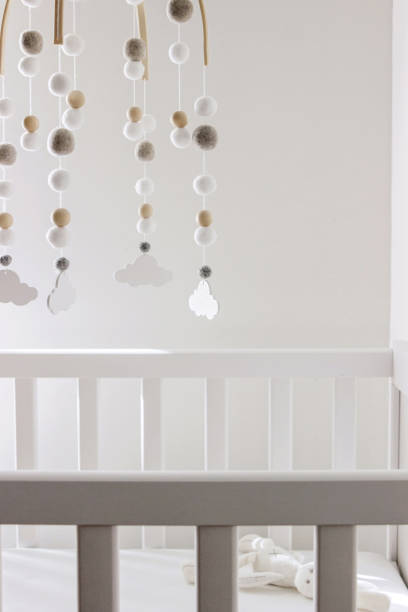 istock cute cloud mobile hanging on crib in nursery room 1389273426