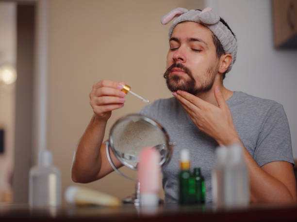 Men's beauty concept. caucAsian guy checking his skin. stock photo