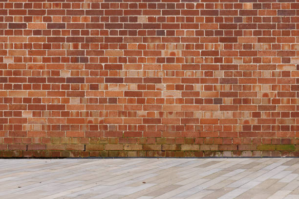 Section of a brick wall in red and brown tones.