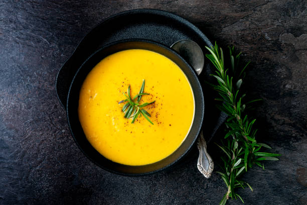 istock Pumpkin soup with linen napkin on dark background. 1389276605