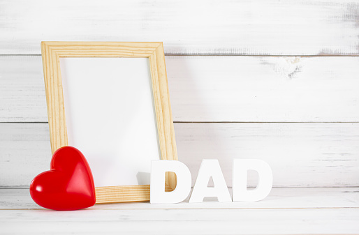 Red Heart with Photo Frame over white wood background. Symbol of love dad concept.