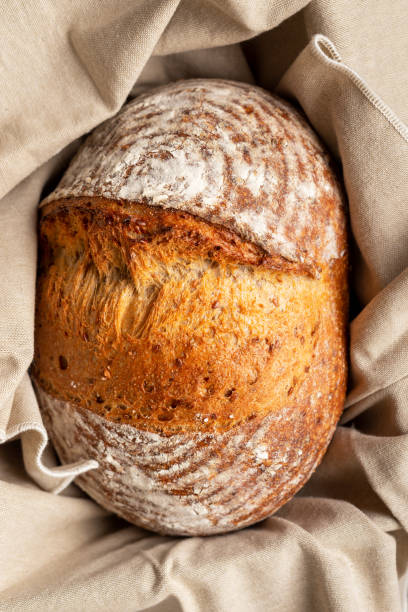 istock Sourdough bread on linen cloth in basket. 1389276817