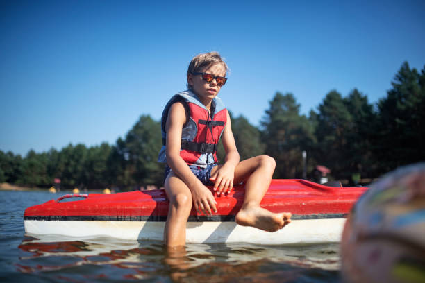 Young happy baby girl enjoying boat ride on a river.