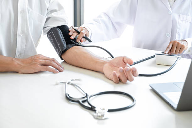 Doctor being measuring examination patient and checking blood pressure to symptom diagnosis illness in hospital stock photo