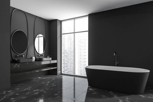 istock Corner view on dark bathroom interior with bathtub, two mirrors 1389285148
