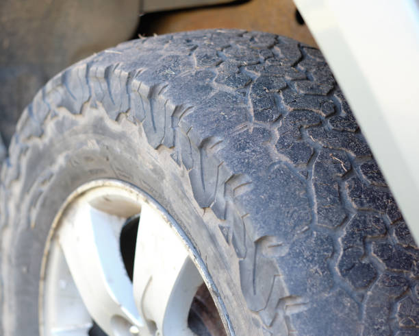 istock A bald tire on a car that needs to be replaced with a new one 1389285216
