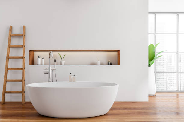 istock Modern bathroom interior with white ceramic bathtub. Hardwood flooring. Panoramic window. Ladder. No people. 3d rendering. 1389285816