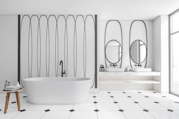 istock Bright bathroom interior with bathtub, two mirrors, sinks, panoramic window 1389286091