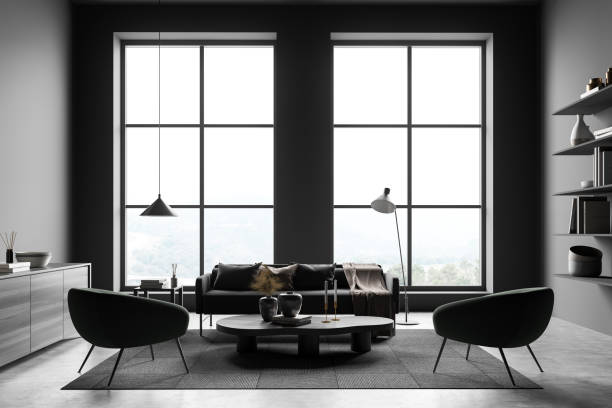 istock Dark waiting room interior with sofa, two armchairs, panoramic window 1389286417