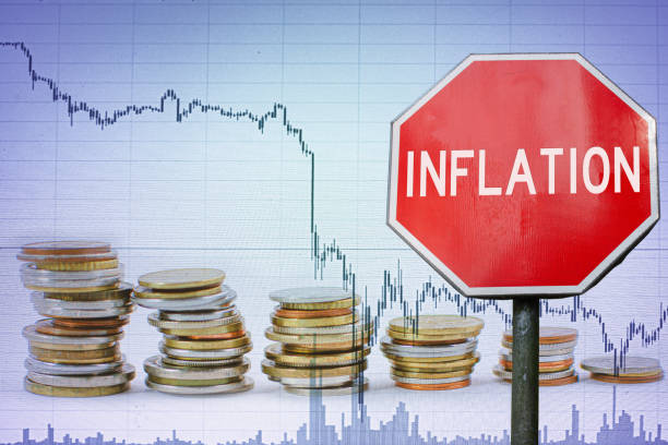 Inflation sign on economy background - graph and coins. stock photo