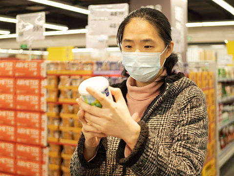 Asian Housewife Choose Goods in Supermarkets