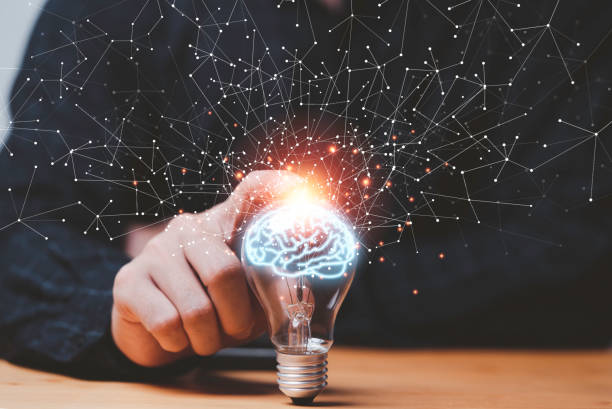istock Businessman hand touching lightbulb with glowing virtual brain and  connection line to creative smart thinking for inspiration and innovation with network concept. 1389291619