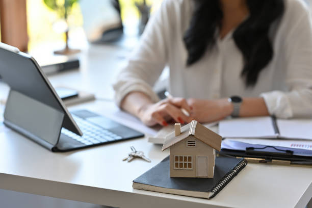 istock Close up with Real estate agent working with tablet and calculator for analyze business data, real estate, home loan, investment and insurance concept. 1389291717