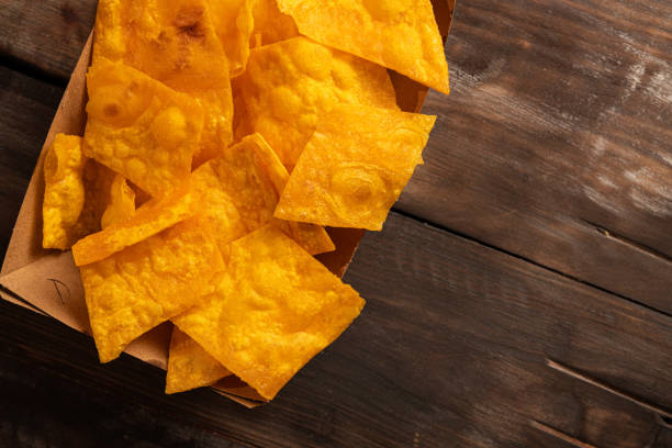 istock Closeup of crispy potato chips in craft packaging 1389291744
