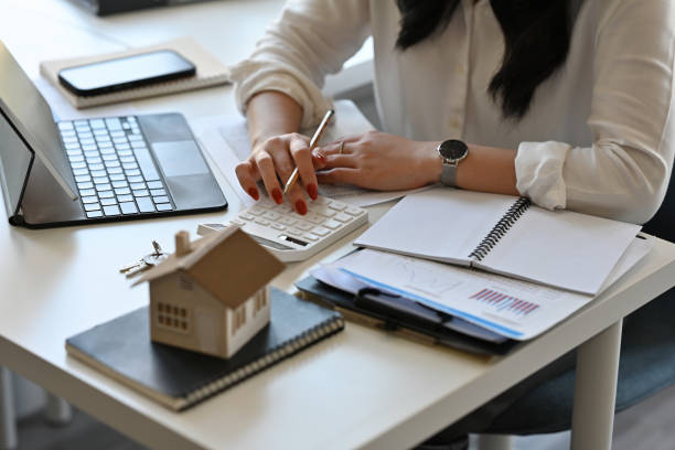 istock Top view with Real estate agent working with tablet and calculator for analyze business data, real estate, home loan, investment and insurance concept. 1389291796