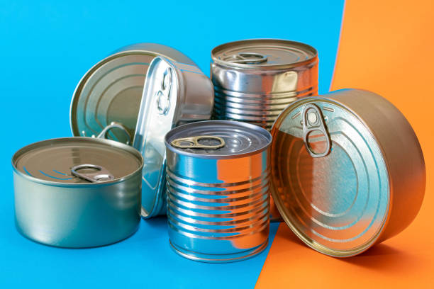 istock A Group of Stacked Tin Cans with Blank Edges on Split Blue and Orange Background 1389291997