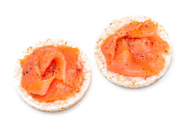 istock Rice Cake Sandwiches with Fresh Salmon Slices Isolated on White 1389292045