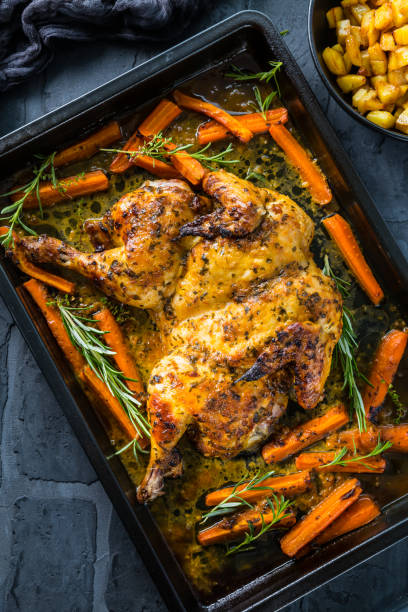 istock Butterflied grilled whole chicken on a black baking pan 1389292787
