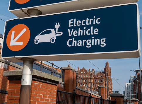 22nd March 2022: Electrical Vehicle Charging street sign in the City of Manchester, guiding drivers to council provided charge points. With the increase in electric vehicles the city council is promoting green initiatives and providing environmentally friendly facilities for car drivers.