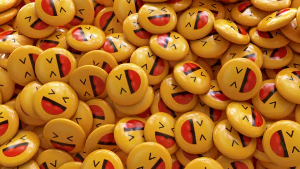 Photo of 3d rendering of a bunch of yellow laughing emojis glossy pills