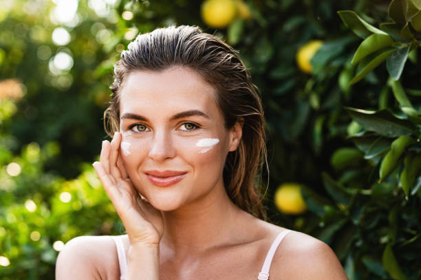 istock Beautiful woman with moisturizing cream under her eyes 1389294276