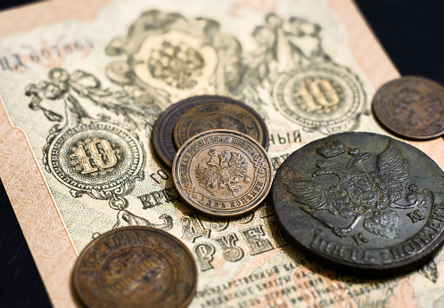 Money of Russian Empire, old coins and banknote. Antique copper coins and paper currency with Imperial coat of arms of Russia. Concept of history, vintage rare coins, economy and numismatics.