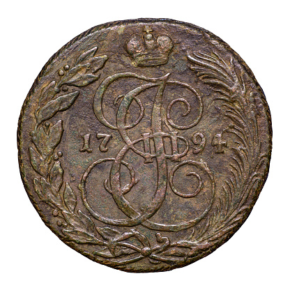 Old coin of Russia, monogram of Catherine II the Great with crown and inscription 1794 on copper vintage money isolated on white background. Concept of Russian Empire, history, rare coin and currency.