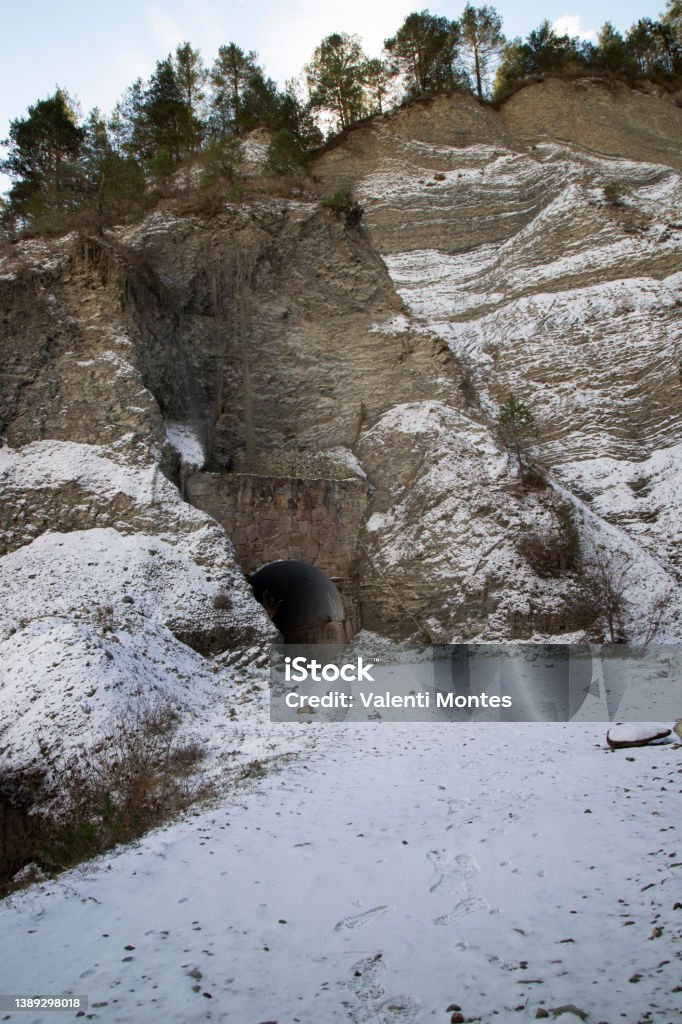 Tunnel in Via del Nicolau Tunnel entrance on a snowy path called Via del Nicolau in Catalonia Adventure Stock Photo