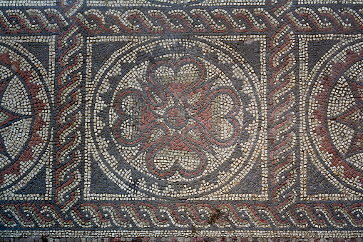 A mosaic figure laid out in the area considered as a courtyard in front of the collapsed section of Terrace Houses of Kuretler Street,. While serving a decorative purpose, the cross-like structure at its center could be seen as a symbolic and minimalist expression of the homeowner or the mosaic craftsman, possibly due to the persecution during the Early Christian Period.