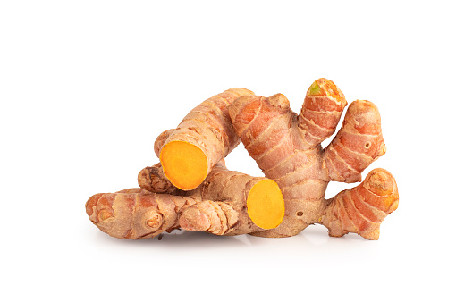 Turmeric (Curcuma longa Linn) rhizome (root) sliced isolated on white background with Clipping Path.