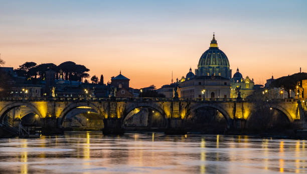 istock St. Angelo Bridge and St. Peter's Basilica at Sunset 1389304191