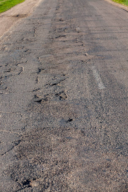 istock an asphalt road with holes 1389305609