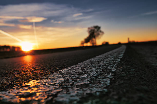 istock dramatic sunset on asphalt road closeup 1389306905