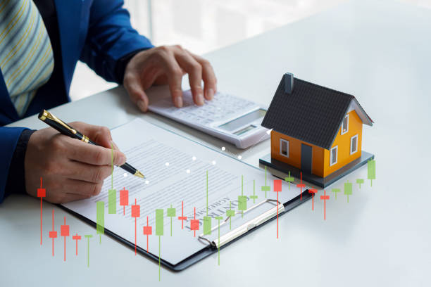 istock Real estate office businessman working with contract documents to offer clients with interest rates, home buying and insurance ideas. 1389307228