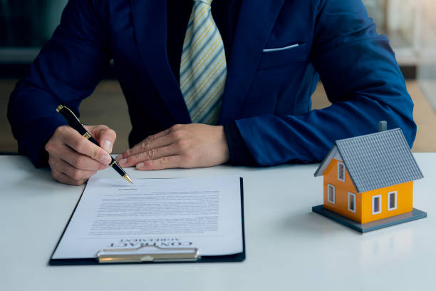 istock Real estate office businessman working with contract documents to offer clients with interest rates, home buying and insurance ideas. 1389307249