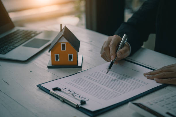 istock Real estate office businessman working with contract documents to offer clients with interest rates, home buying and insurance ideas. 1389307306